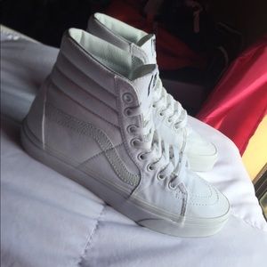 All white Hightop Vans